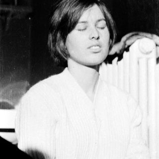 A person singing or speaking with eyes closed.