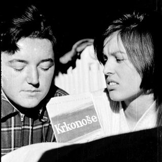 Two people sharing a package of Krkonoše cookies.