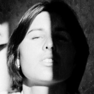 A person lying down with eyes closed.