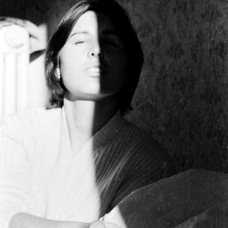 A person lying down with eyes closed.