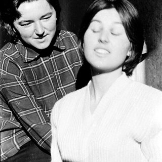 Two women sharing a tender moment indoors.