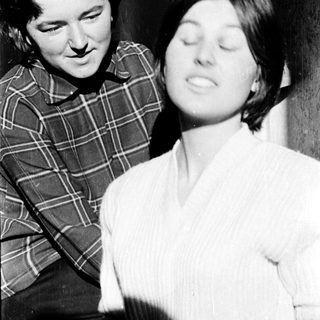 Two women sharing a tender moment indoors.