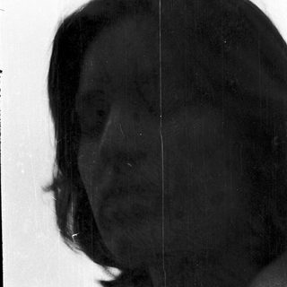 Silhouette of person with short hair.