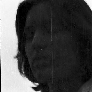 Silhouette of person with short hair.