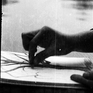 Person writing or drawing on paper.