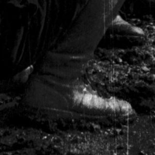 Person digging or planting in a trench.