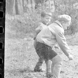 Two people playing in rain outdoors.