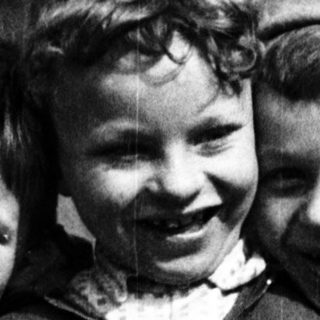 Three cheerful boys posing together outdoors.