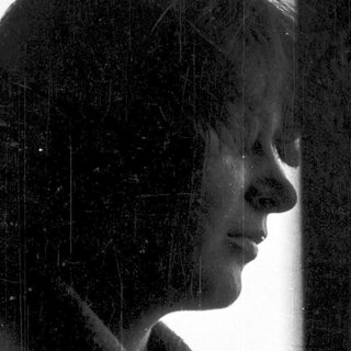 Silhouette of person looking out in rain.