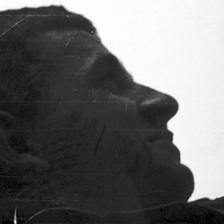 Sculpture of weary soldier in contemplative pose.