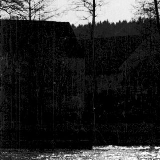 Rural river scene with leafless trees and distant forest.