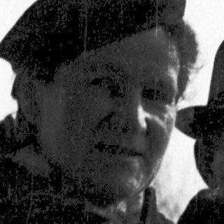 Two men in vintage attire standing outdoors.