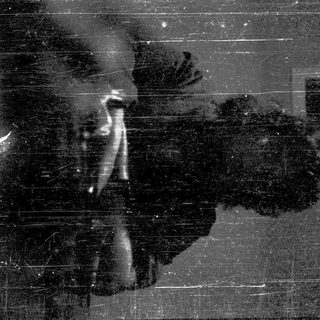 Silhouette of person sitting indoors during rain.
