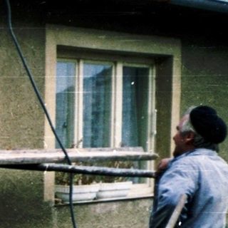 Construction workers repairing or rebuilding a brick chimney.