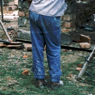 Construction crew building wooden structure outdoors.