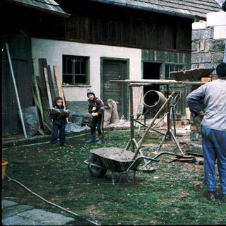 Construction crew building wooden structure outdoors.