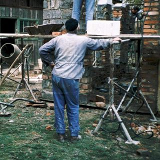 Construction crew building wooden structure outdoors.
