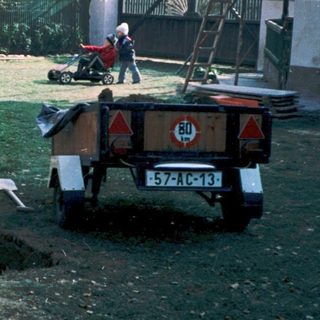 Men working on garden maintenance with tools.
