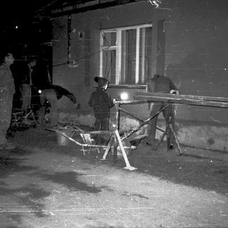 People repairing damaged street infrastructure at night.