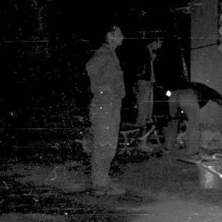 People repairing damaged street infrastructure at night.