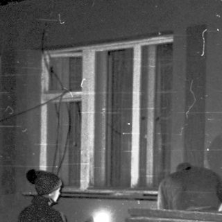 People repairing damaged street infrastructure at night.