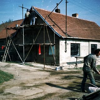 Renovation crew working on roof and exterior.