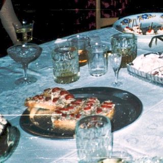 Celebratory gathering with cake, glasses, and smiling women.