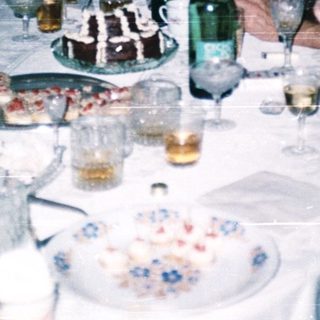 Group enjoying meal and drinks at a festive indoor gathering.