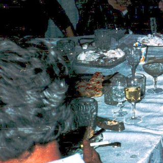 Social gathering with people seated at a table.