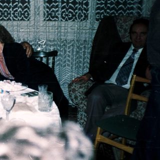 Group of men enjoying a meal together indoors.