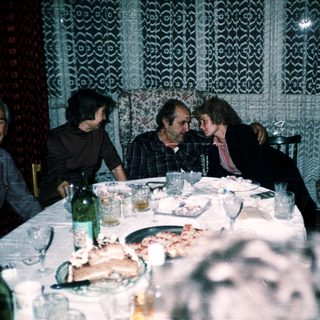 Group of men enjoying a meal together indoors.