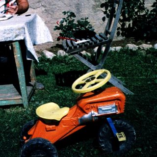 Family picnic outdoors near a house.