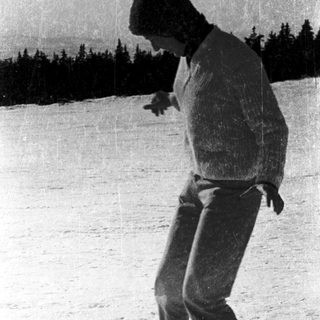 Person skiing on snow-covered slope.