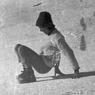 Person snowboarding downhill on snow-covered slope.