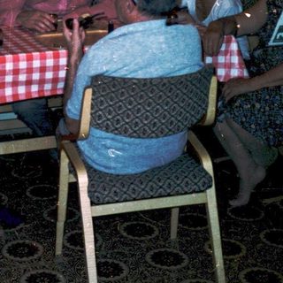 Family gathering around a table in a cozy indoor setting.