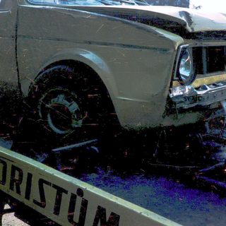 Severely damaged car on tow truck.