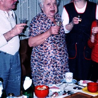 Family gathering indoors playing charades or guessing game.