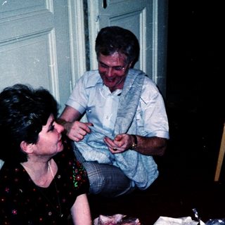 Family gathering with food and cards indoors.