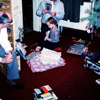Family opening holiday gifts indoors.