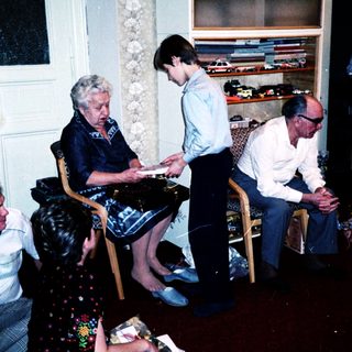 Family playing board game indoors together.