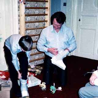 Family opening holiday gifts indoors.