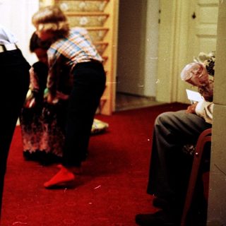 Family opening Christmas presents indoors.
