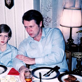 Family meal scene with man and boy at table.
