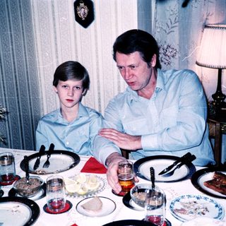 Family meal scene with man and boy at table.
