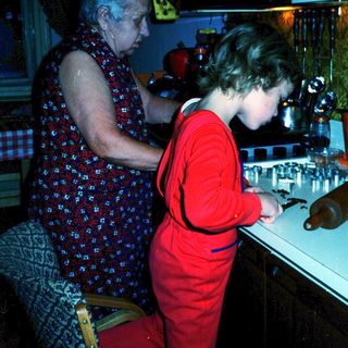 Two women at a bar counter, one serving drinks.