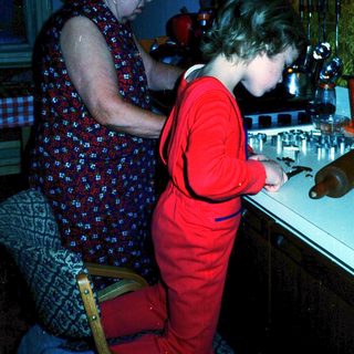 Two women at a bar counter, one serving drinks.