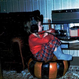 Child playing with vintage electronic music keyboard.