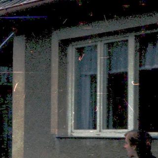 Children playing outside an old, weathered house.