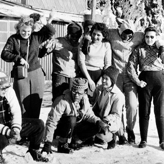 Group of people posing outdoors in winter clothing.