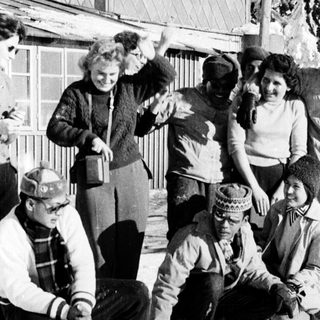 Group of people posing outdoors in winter clothing.